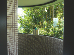 The 3-room master suite contains a large tile and glass semi-circular shower bay.