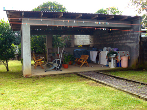 In the long back yard is a large rancho which has the laundry as well as a fitness area and furniture.