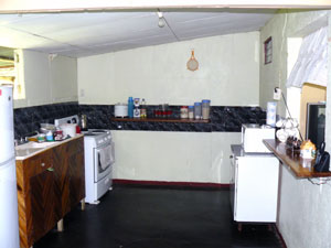 The kitchen is large and has cupboards.