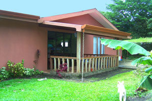 The back veranda provides a view to the bird-rich forest.