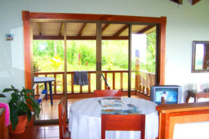 The dining area looks both eastward to the forest and west to the Pacific.