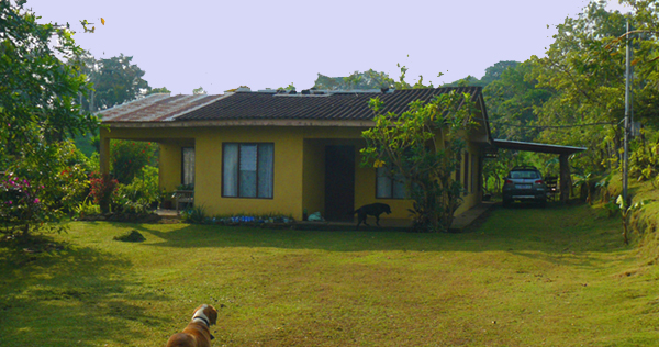 The 2BR 2BA house and its grassy yard beside the lane through Chimurria.