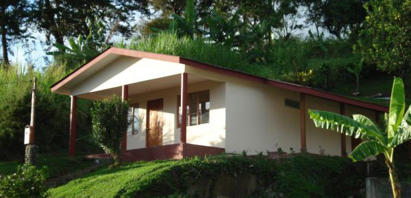 The 2-bedroom home is located right across the lake highway from a pretty arm of Lake Arenal.