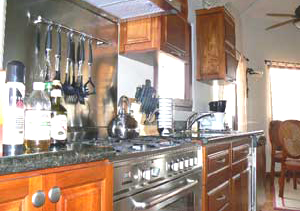 This kitchen has an Italian gas range and beautiful Costa Rican hardwood cabinetry.