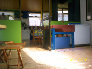 A handy and roomy laundry area is just just outside the glass-walled kitchen. 