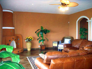 The spacious furnished home has an adobe-style corner fireplace. 