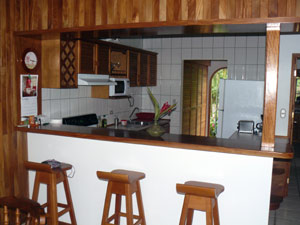 The kitchen has a breakfast bar with nice custom0made stools.