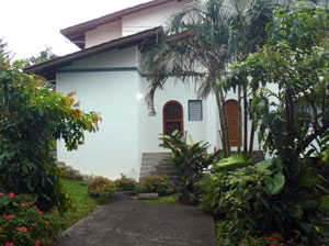 The lane side of the townhouse has a paved parking pad framed by the community's well tended landscap-ing.