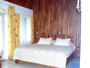 The roomy master bedroom has a lofty ceiling, fine views through large windows and a double door to the wide balcony.