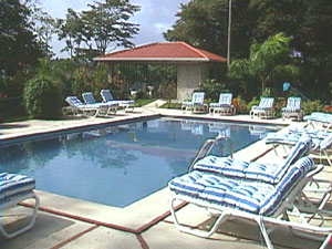 Rainbow Bay's main swimming pool has a wide apron all around it with many lounge chairs.