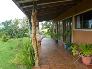 The view north along the veranda lads to open fields and northern hills.