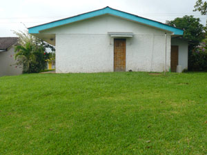 There's a large lawn at the back of the house before the property descends to a banana grove. 