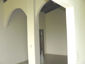 The "great room" has been partially divided by high arches.