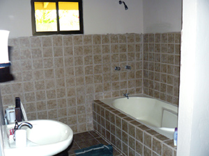 The master bathroom has a tub and shower as well as an anteroom for make-up or computer use.