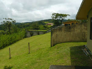 The view to the north from the patio shows the neighboring lot (on other side of half-wall) which also is for sale by these owners.