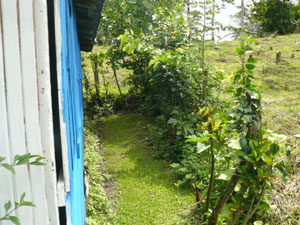 Wooded hills and fields surround the small lot.