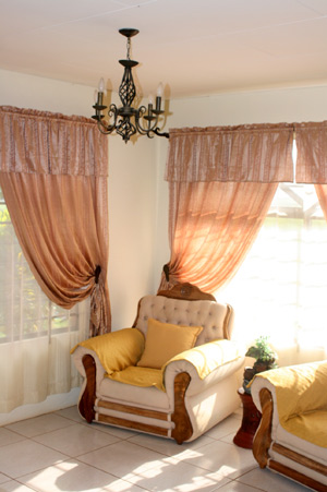 Large windows and high cheilings with chandeliers provide a pleasant ambiance in the living room and other rooms. 