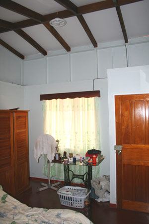 The bedroom is spacious and has a high, attractive ceiling.