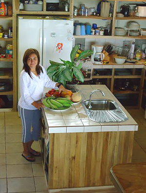 The kitchen island has a sink and plenty of space for meal preparation.