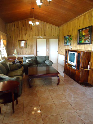 A view of the sala or living room, including its handsome cathedral ceiling.