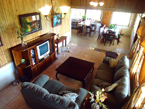 The huge-L-shaped open area turns the corner from the kitchen and dining area into a large, living room with cathedral ceiling.