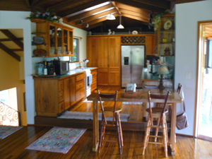 To the left of the kitchen is the stairway. To the right is the sun room. 