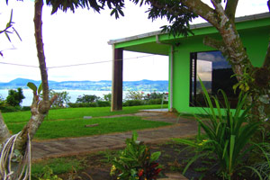 The master bedroom corner of the house has large windows overlooking the lake.