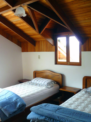 The upstairs bedrooms have dormer windows and balconies. 