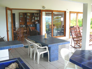 The wide inviting veranda is like an extension of the living room becaue of the large windows and doors. 