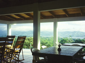 The deep, house-wide veranda has an outdoor kitchen and built-in tables.