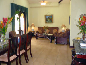 Also in the kitchen hall are the dining area and the living room, which has etched-glass double doors leading to the garden veranda. 