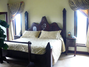 In the master bedroom is this massive bed, part of the custom furniture that is included with the house. 