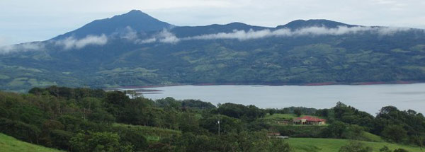 The 4,000 square foot house is dwarfed by it setting with dormant Tenorio Volcano rising impressively n th other side of Lake Arenal.