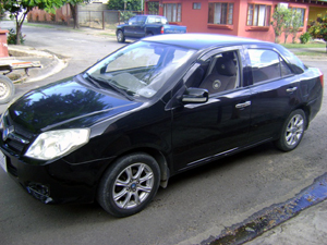 The Geely GT parked on the wide cul-de-sac street in front of the house in Liberia. 