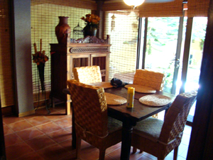 The andsome dining room opens wit tall glass doors to the courtyard and pool.