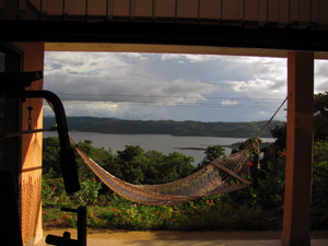 From inside the house, here's a view past the veranda and a hammack to the beautiful lake.