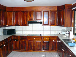 The roomy kitchen is filled with beautiful upper and lower cabinets by the owner, a professional woodworker and boat builder.