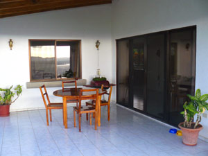 This wide covered patio provides outdoor dining with lake and mountain vistas.