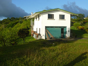 The main workshop with apartment above sits below the main home's promontory.