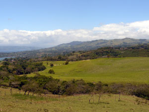 This view from the lake side of Parcelas shows the hills of neighboring La Tejona with the Tronadora peninsula in the distance. 