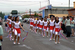 A high school marching troop performs on Independence Day.