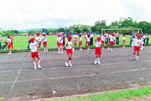 Schoolchildren perform on Independence Day beside the soccer field at the center of Tronadora. 