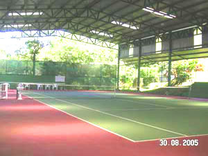 A roofed tennis court at the marina community