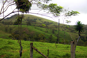 The hillsides rise up high and unpopulated above the lot.