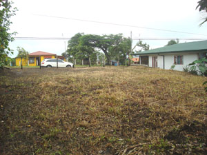 Across the highway from the lot is a house. 