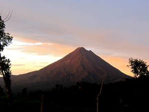 Another beautiful temperate day starts with the sun rising behind the volcano.