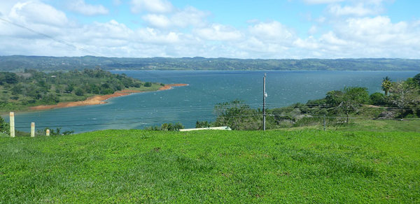 The lot broadly lawned building area has wonderful cove and lake and mountain views above the long slope to the water. 