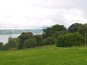 The terrain in front of the lot consists of a long pastured slope to the water's edge.