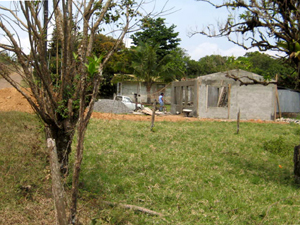 On the west side, a house is under construction on a similar lot.