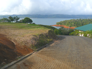 The lot is reached by roads on two sides, one of them a wide road with herringbone pavers.